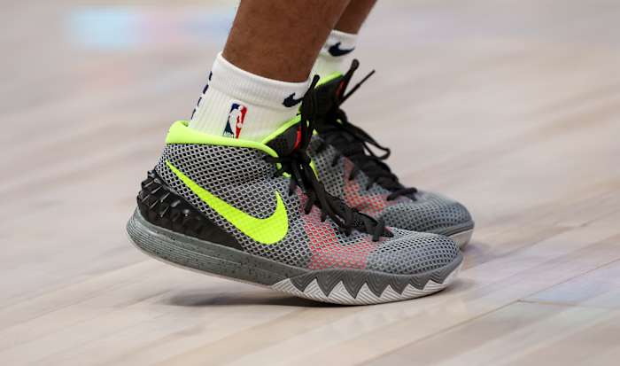 Grey and green Nike Kyrie shoes.